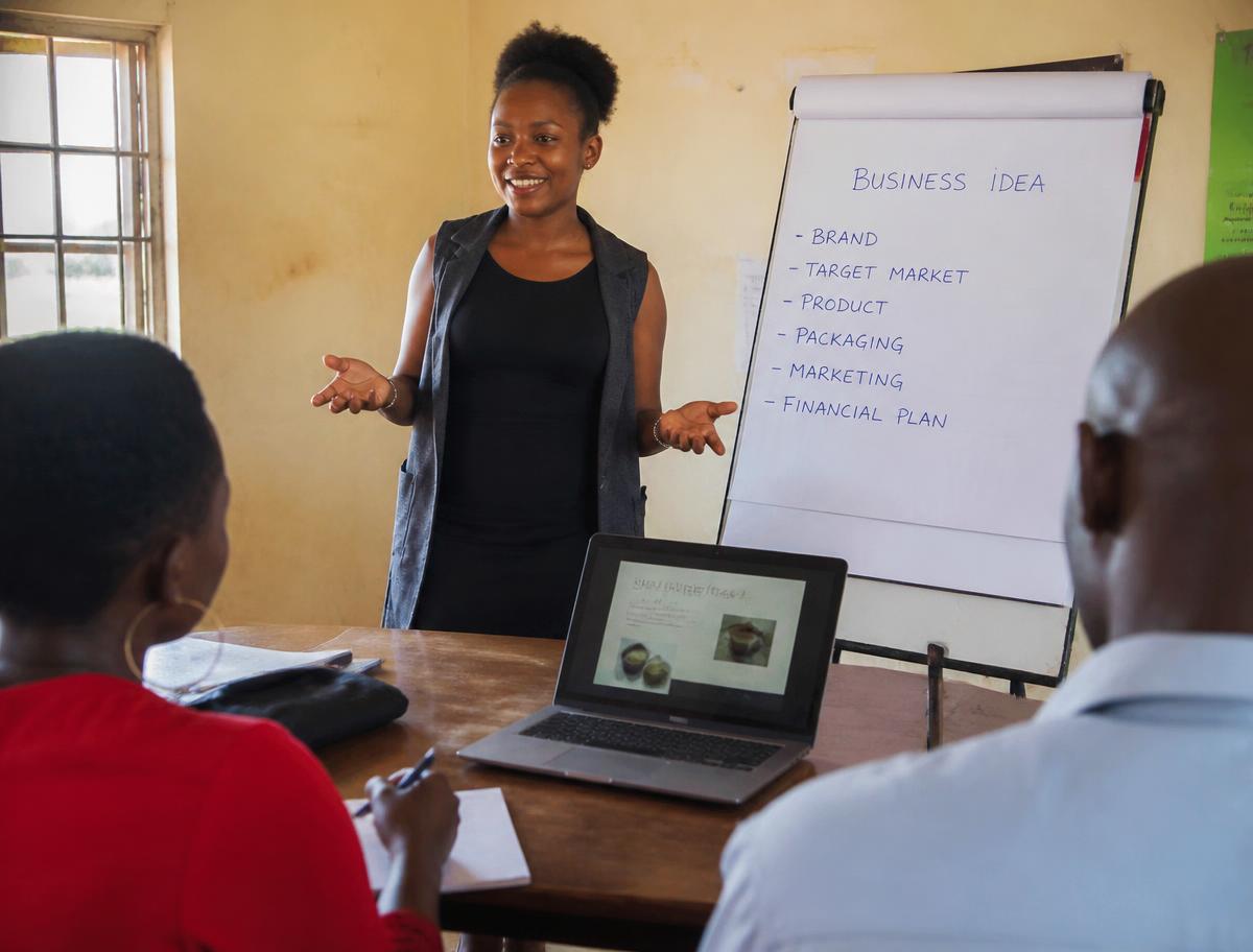 A young entrepreneur presenting her business plan to a small group